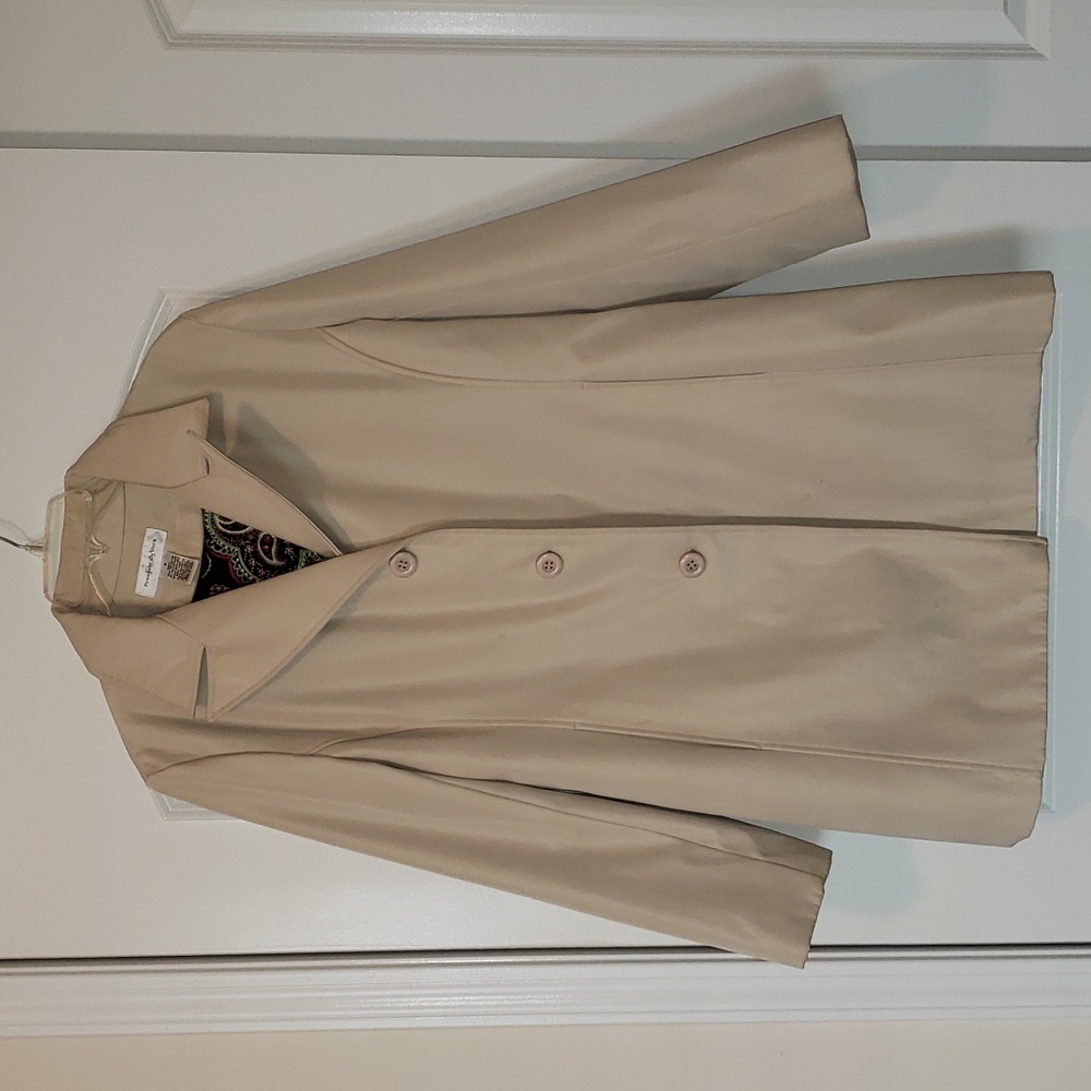Long water resistant cream colored trench coat. Size Small.